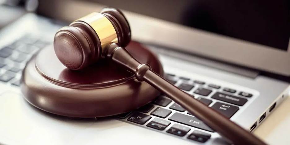 Gavel lying on top of a computer keyboard.