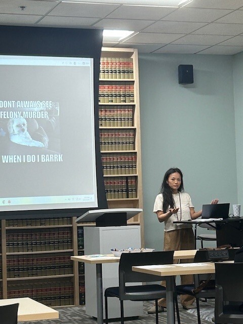 A woman giving a Power Point presentation.